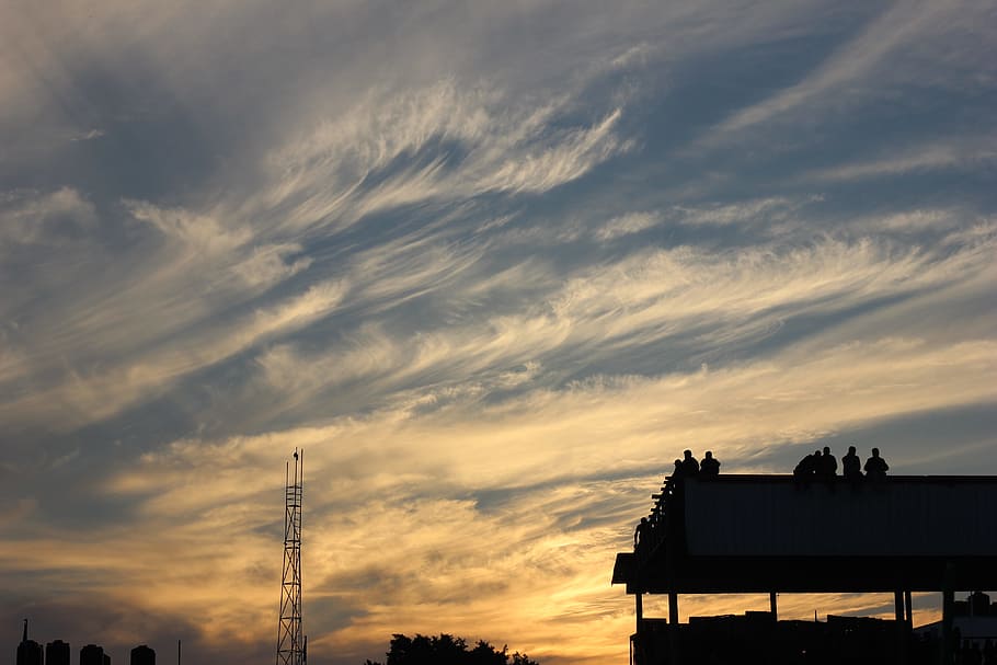 Silhouette of Building With People Standing during Golden Hour HD wallpaper