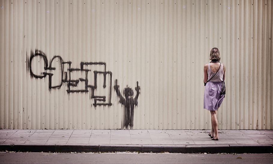 woman in white tank top and purple skirt stands facing graffiti painted wall, HD wallpaper