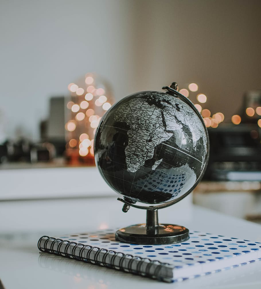 black and gray desk globe on notebook, focus on foreground, close-up HD wallpaper