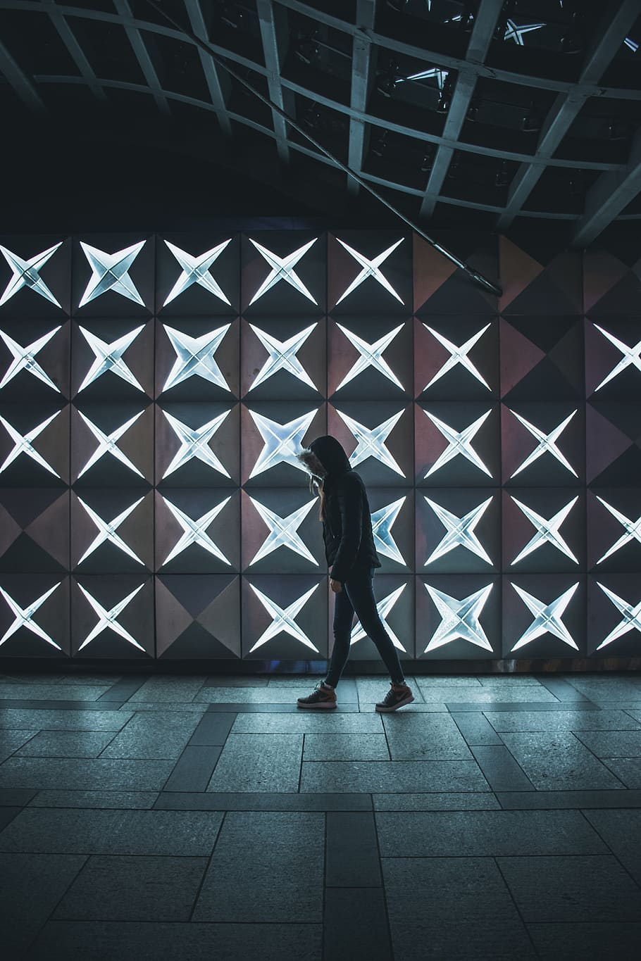 person walking inside building beside lighted wall, real people HD wallpaper
