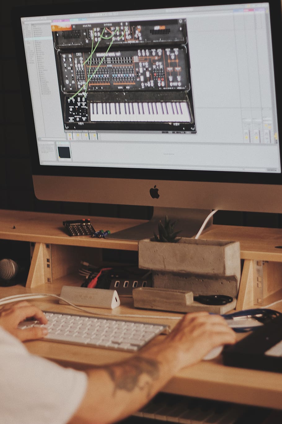 person using iMac computer set with digital piano application HD wallpaper