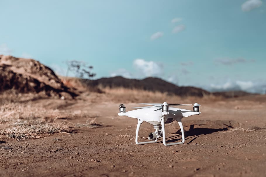 white drone on brown soil, day, nature, sky, environment, no people HD wallpaper