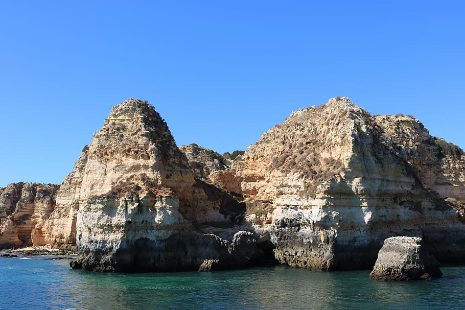sea, sun, rock, rock formation, rock - object, water, sky, solid HD wallpaper