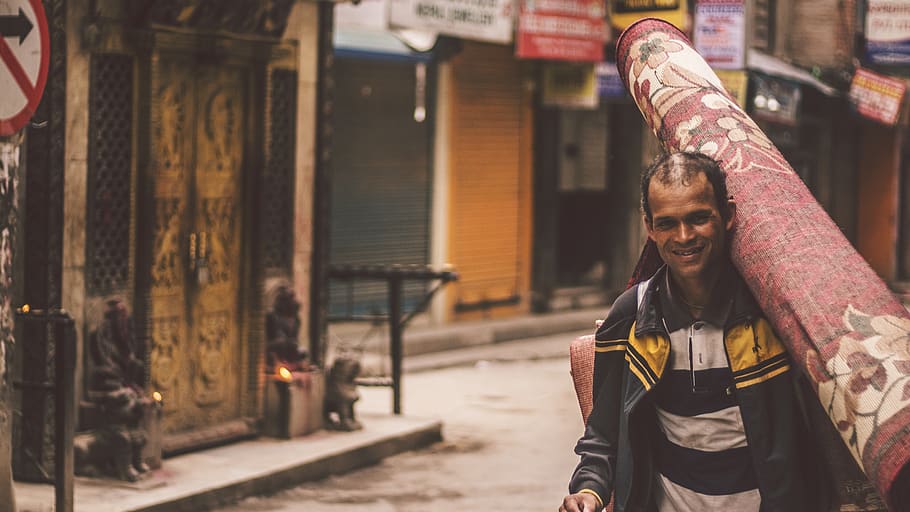 smiling man carrying carpet, person, human, face, apparel, clothing HD wallpaper