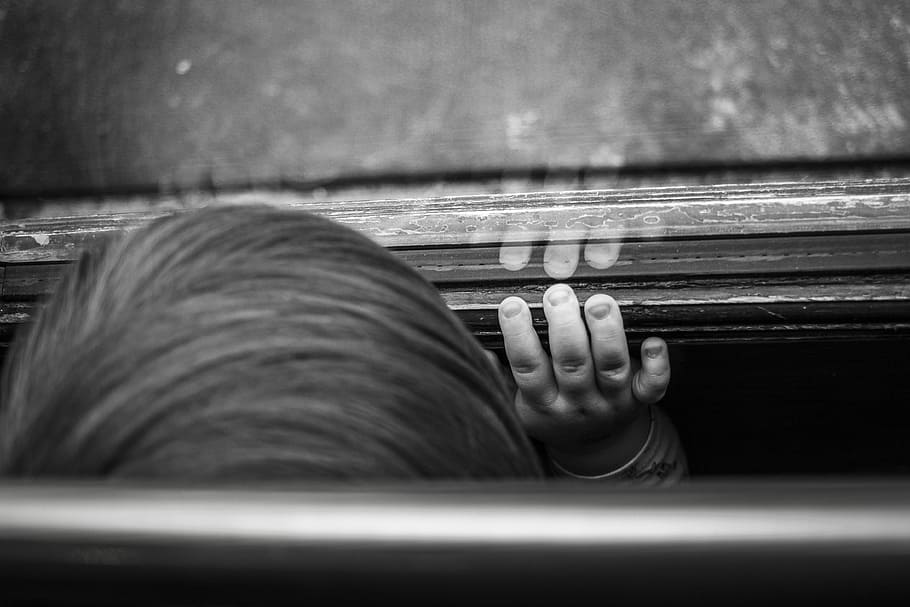 grayscale photography of boy standing in front of glass mirror HD wallpaper