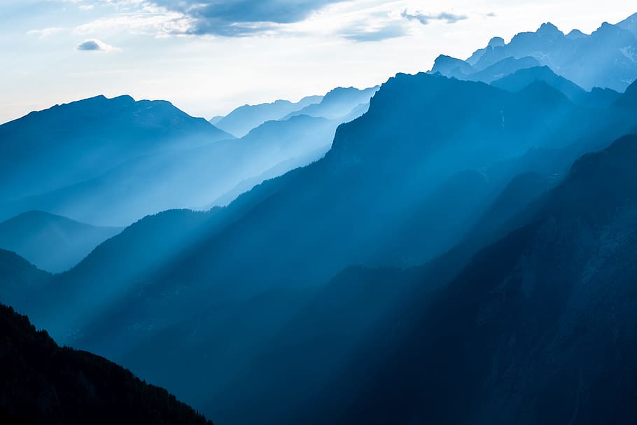 landscape photography of mountains while rays passing through it