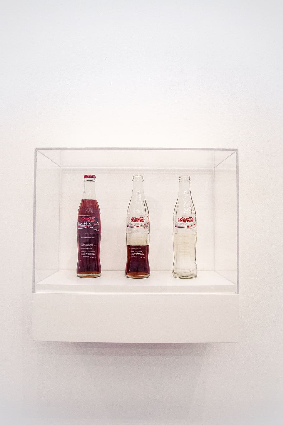 three Coca-Cola bottles, white background, still life, indoors HD wallpaper