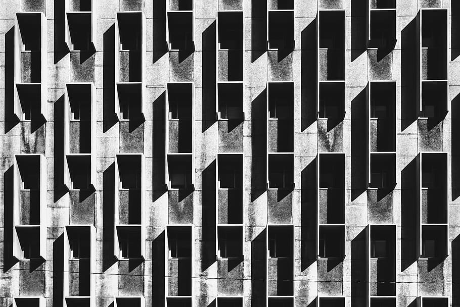 minimalist photography of gray concrete multi-storey building