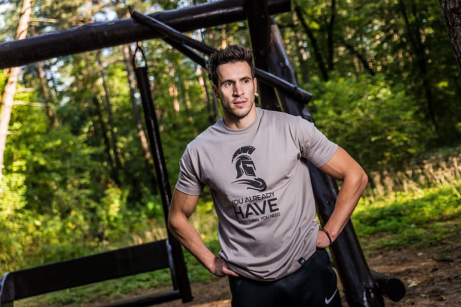 Man Wearing Brown Crew-neck T-shirt Standing Near Brown Wooden Swing at Daytime HD wallpaper