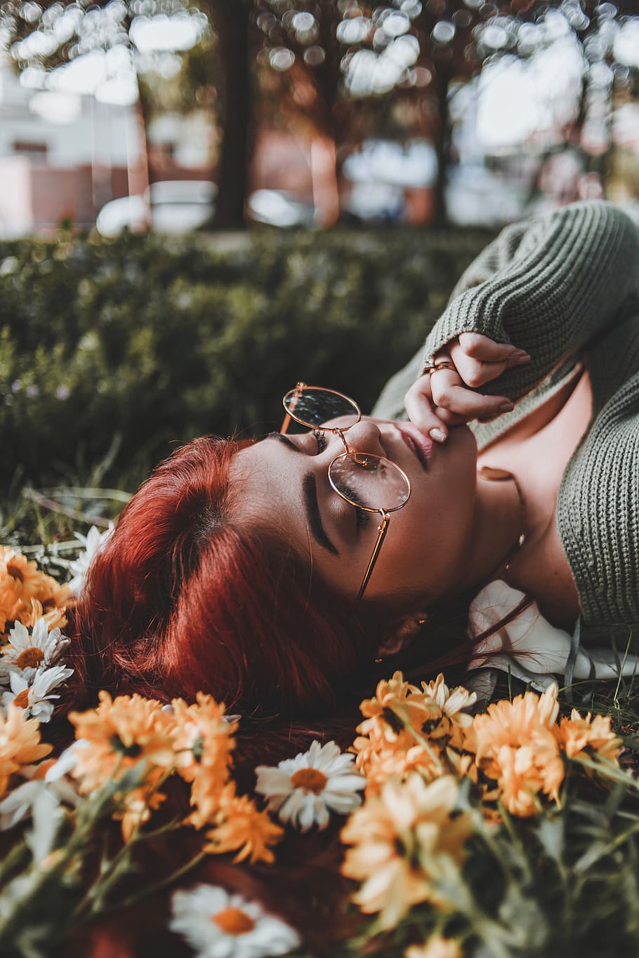woman lying on flower bed with right hand on chin, plant, human