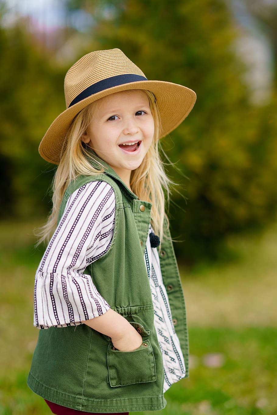 selective focus photography of girl smiling wearing sun hat, apparel