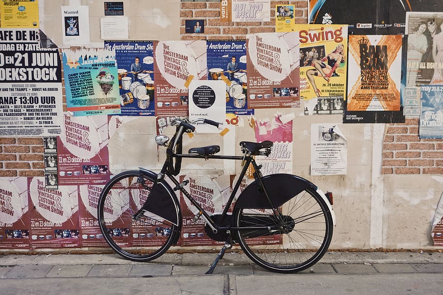 black bicycle parked beside a wall full of poster, bike, flyer, HD wallpaper
