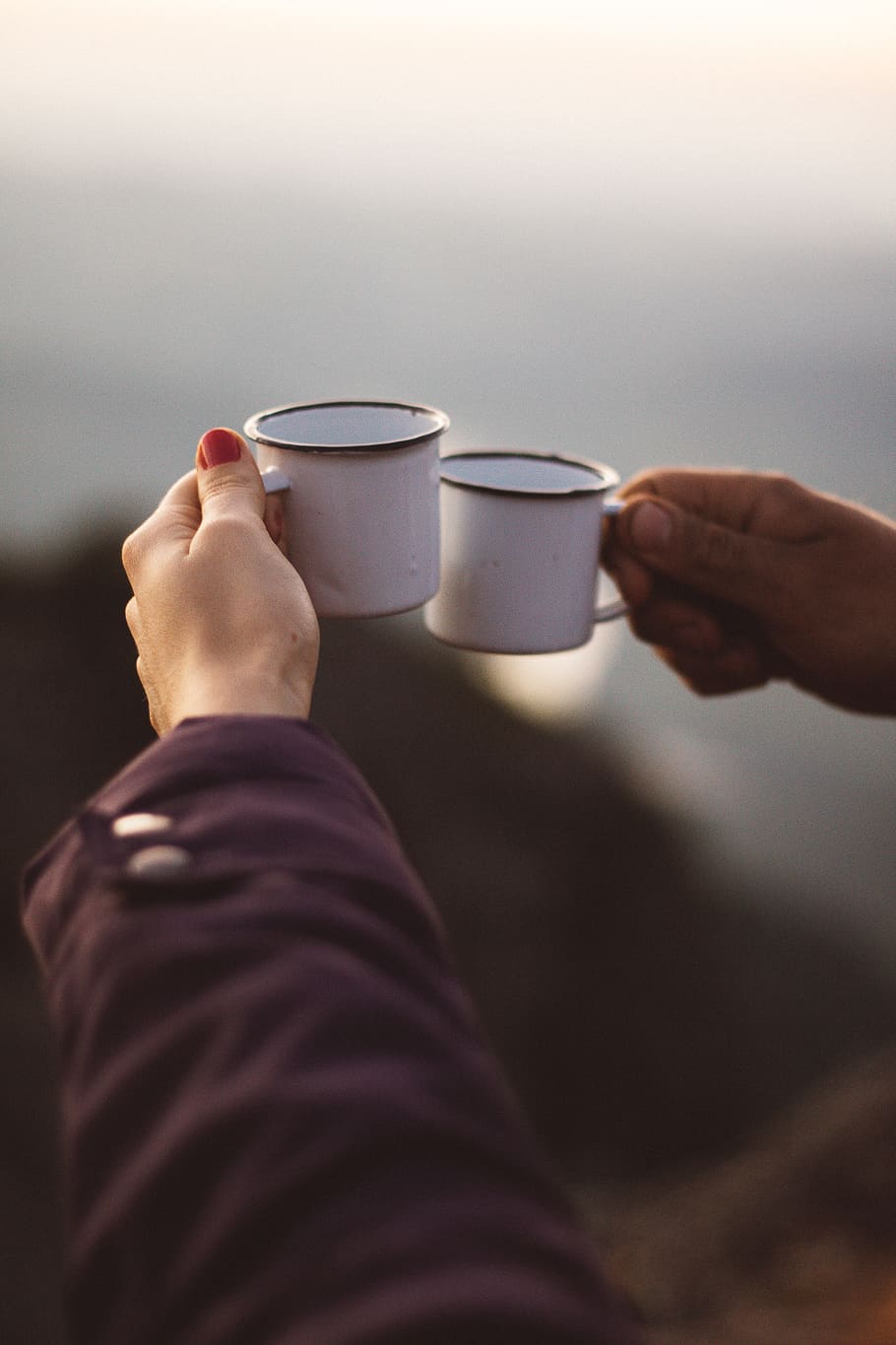 Person Holding Two White Cups, hands, metallic cups, toasting HD wallpaper