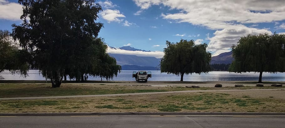 White Van Parked, car, clouds, daylight, grass, mountain, road HD wallpaper