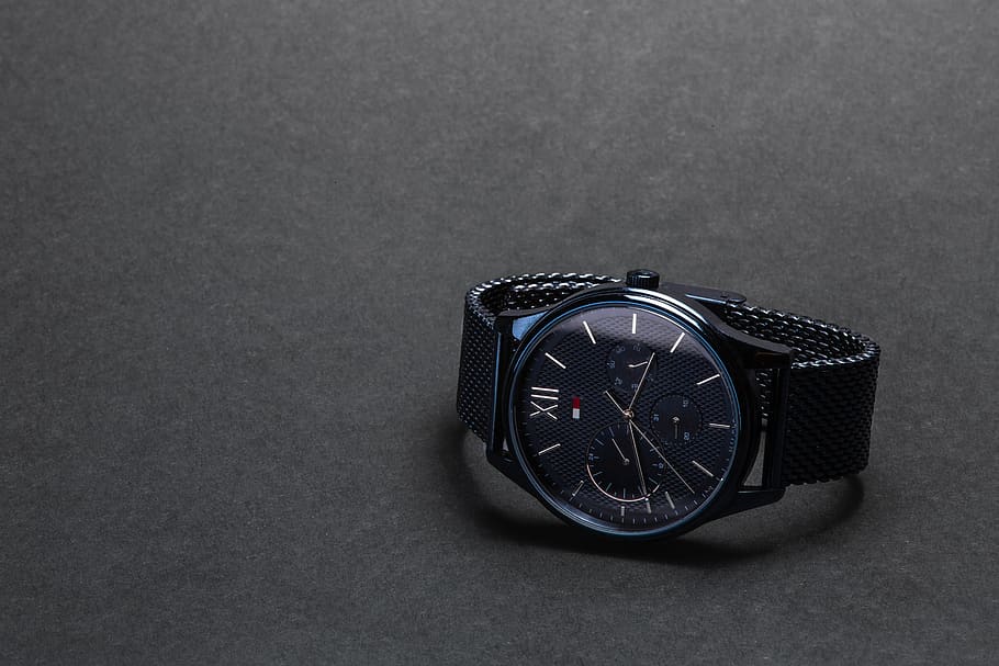 round black Tommy Hilfiger chronograph watch on black surface, HD wallpaper