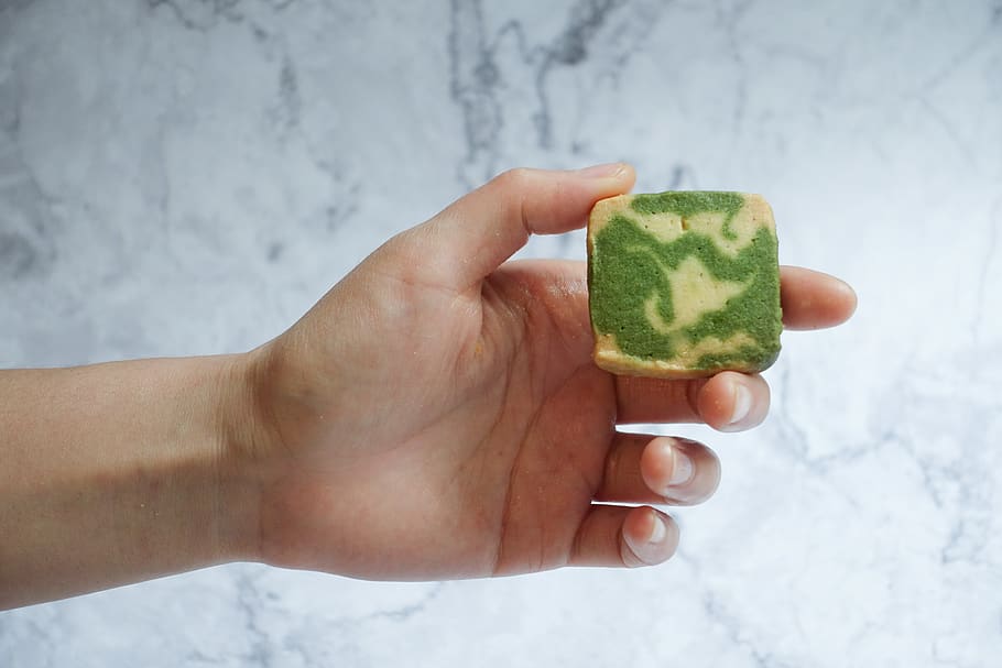 Person Holding Pastry, biscuit, cookie, food, hand, matcha, shape HD wallpaper