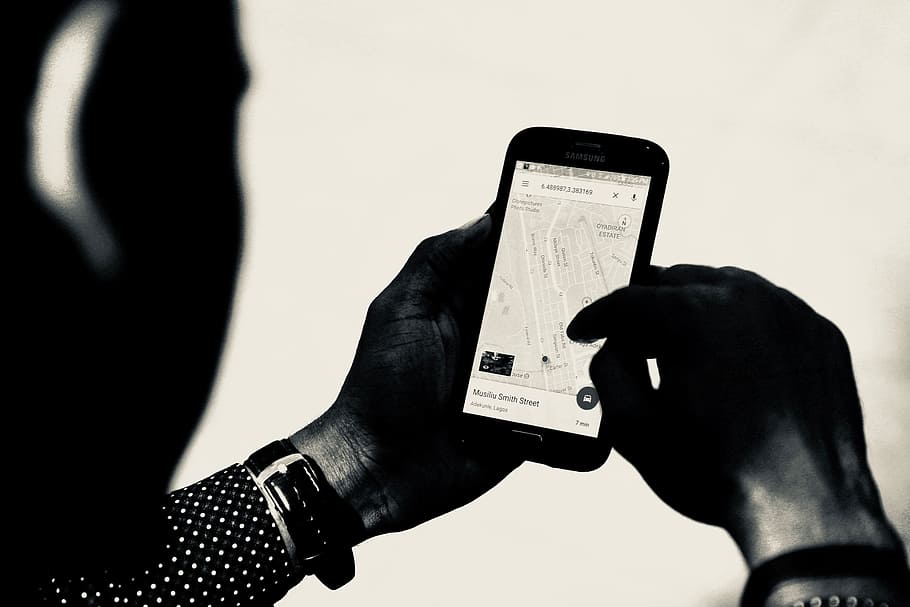 person using Google map, pin, holding phone, black and white HD wallpaper