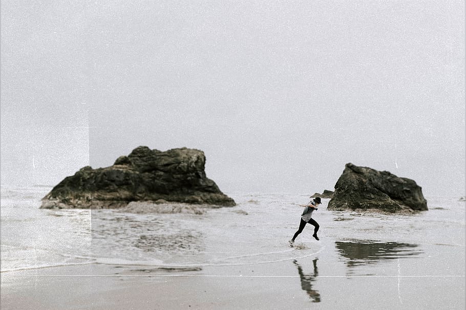 man running on beachside, sea, water, rock, rock - object, real people HD wallpaper