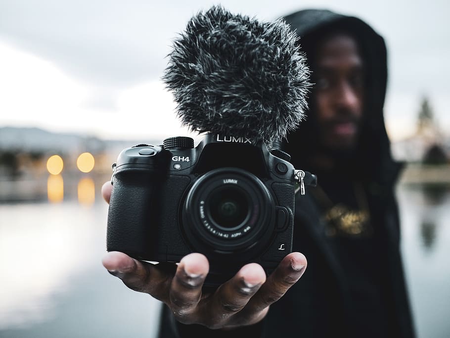 Man Holding Lumix Digital Camera, blurred background, camera lens HD wallpaper