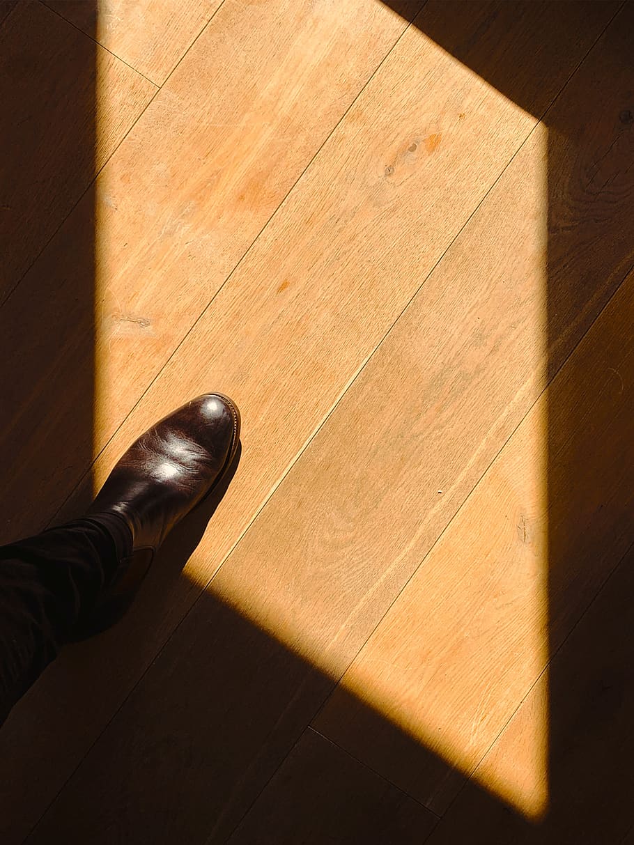 person standing on brown wooden floor, apparel, clothing, plywood