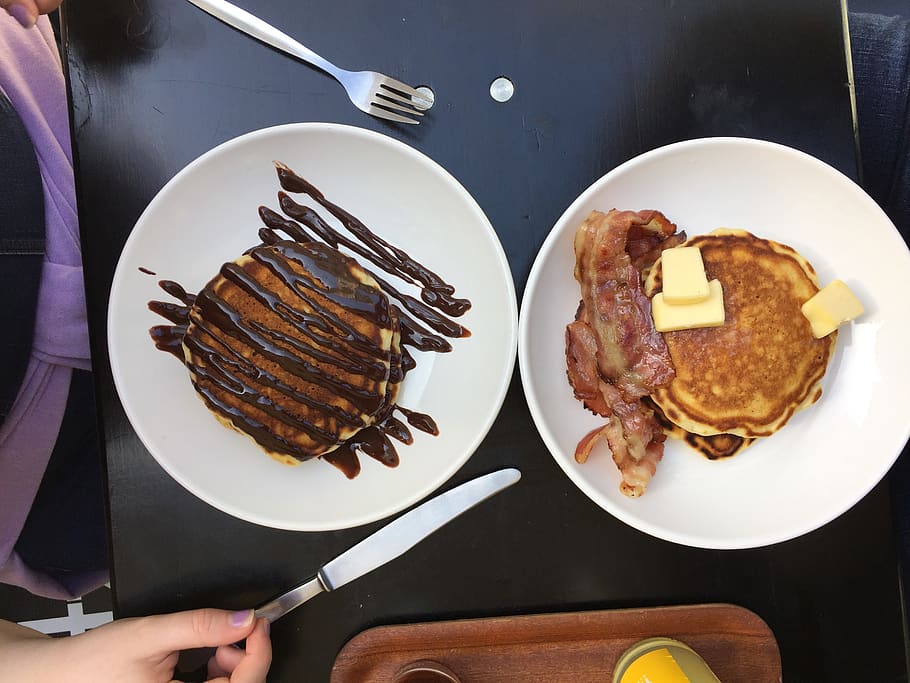 Chocolate covered pancakes., food, food and drink, plate, human hand HD wallpaper