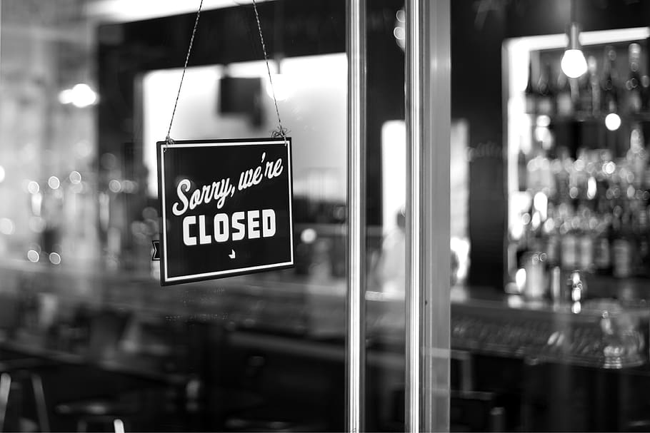 sorry, we're closed signboard hanging on glass door, shop, text