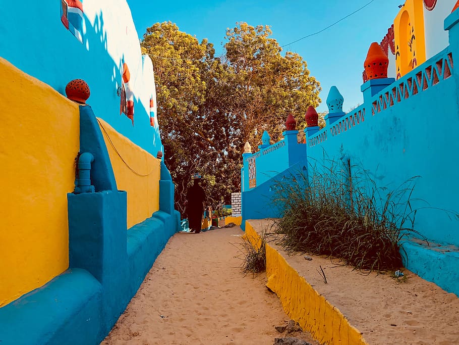 pathway near blue painted wall, egypt, toy, slide, aswan, town