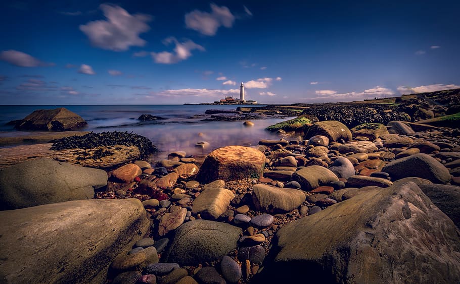 Worm's-eye View Photography of Lighthouse, beach, boulders, dawn HD wallpaper