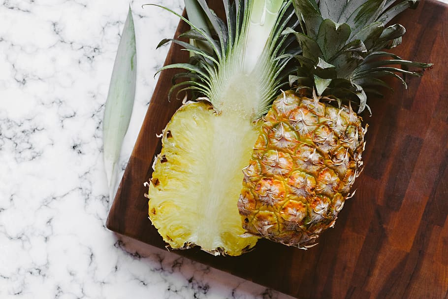 sliced in half pineapple, fruit, plant, food, cutting board, butcher block, HD wallpaper