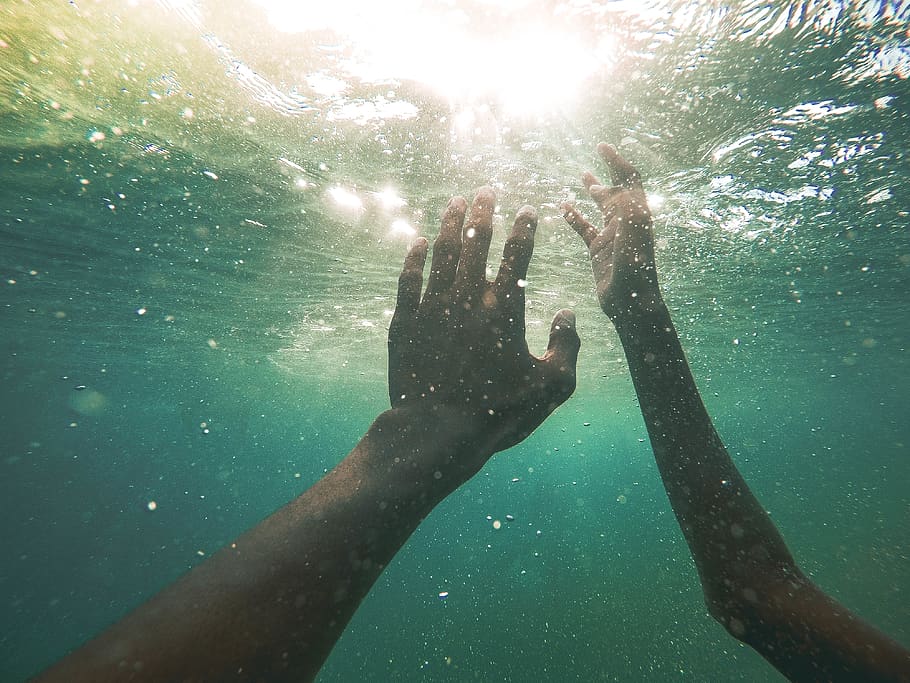 two persons underwater, human hand, one person, real people, sunlight HD wallpaper