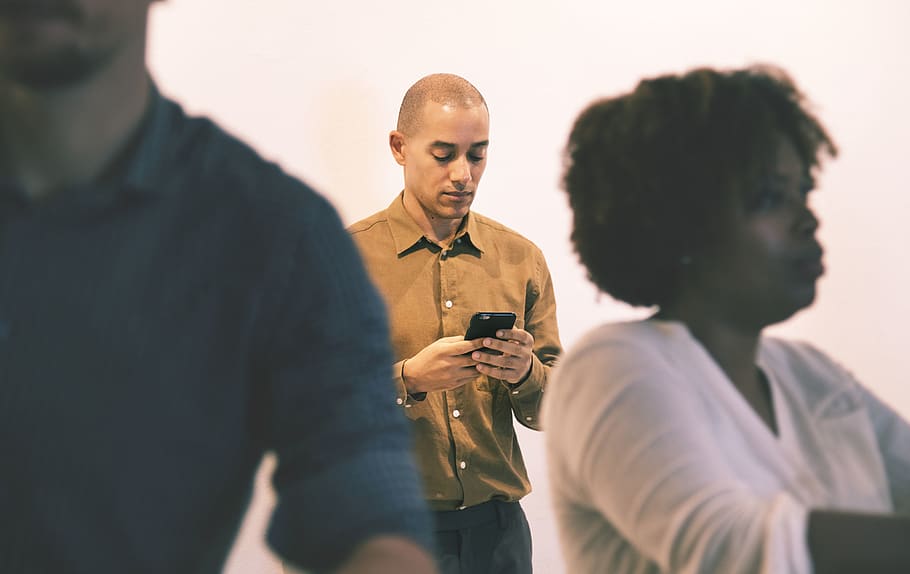 Man Holding Smartphone Near Wall, cellphone, device, digital HD wallpaper