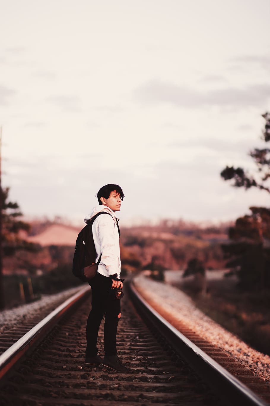 man standing on train rails during daytime, transportation, railway HD wallpaper