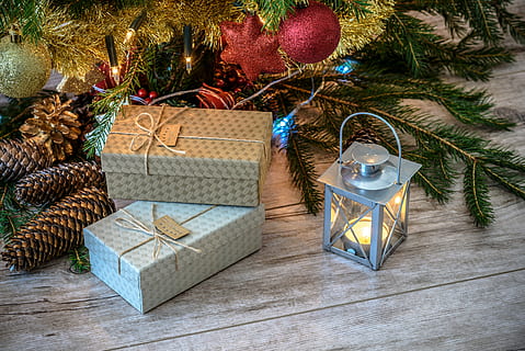 Lit Candle Inside Lantern Beside Gift Boxes and Christmas Tree HD wallpaper