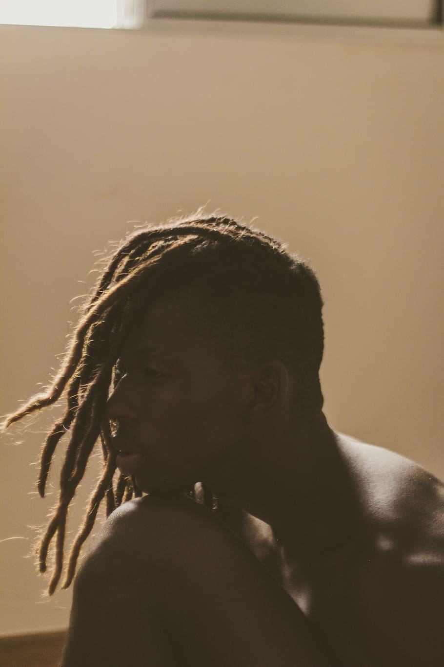 Man Resting His Head On His Knee, backlit, dreadlocks, person HD wallpaper