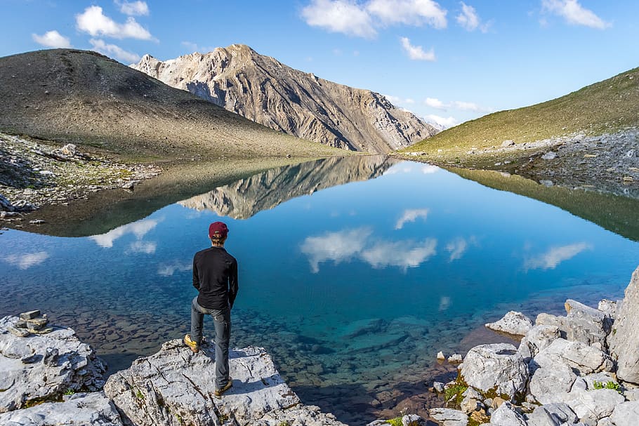 man standing on seacliff facing mountain range, nature, person HD wallpaper
