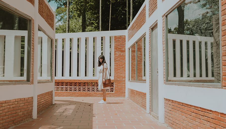 Woman Standing in the Middle of Brick Wall House, architectural design HD wallpaper