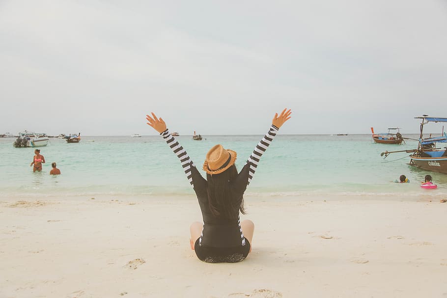 Woman Sitting at the Beach Near Boats and People during Day, child HD wallpaper