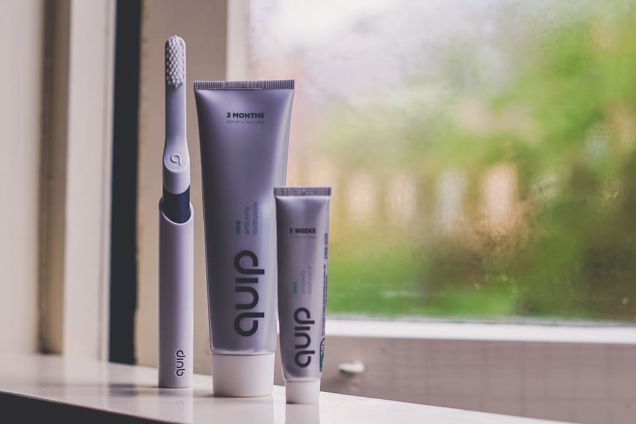 three assorted toiletries on glass window, focus on foreground HD wallpaper