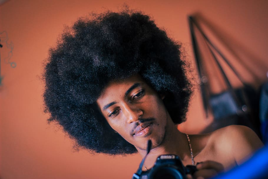 man holding camera, hair, afro hairstyle, person, human, people HD wallpaper