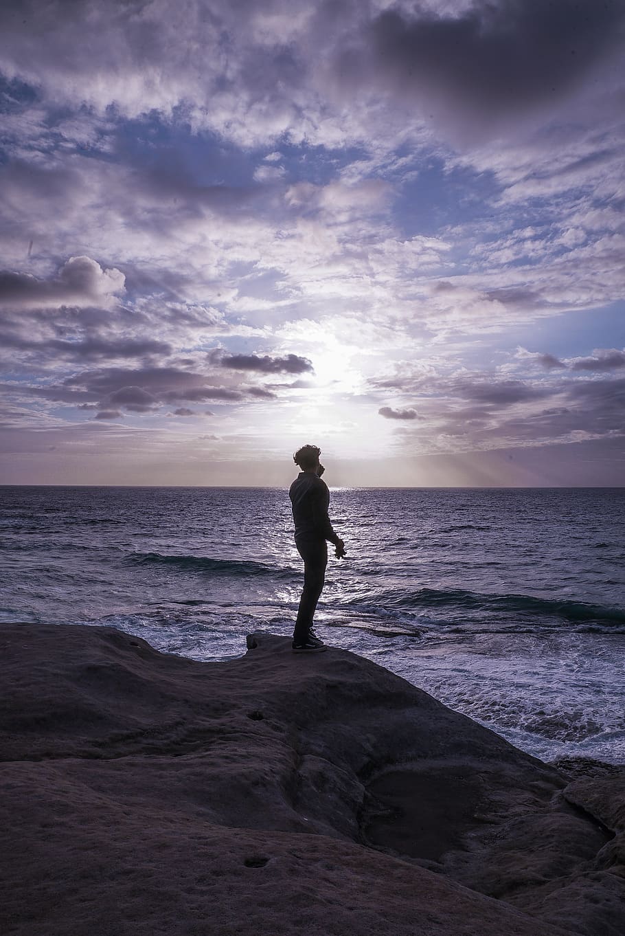 Photo of Man Standing on Rock Formation, backlit, beach, clouds HD wallpaper