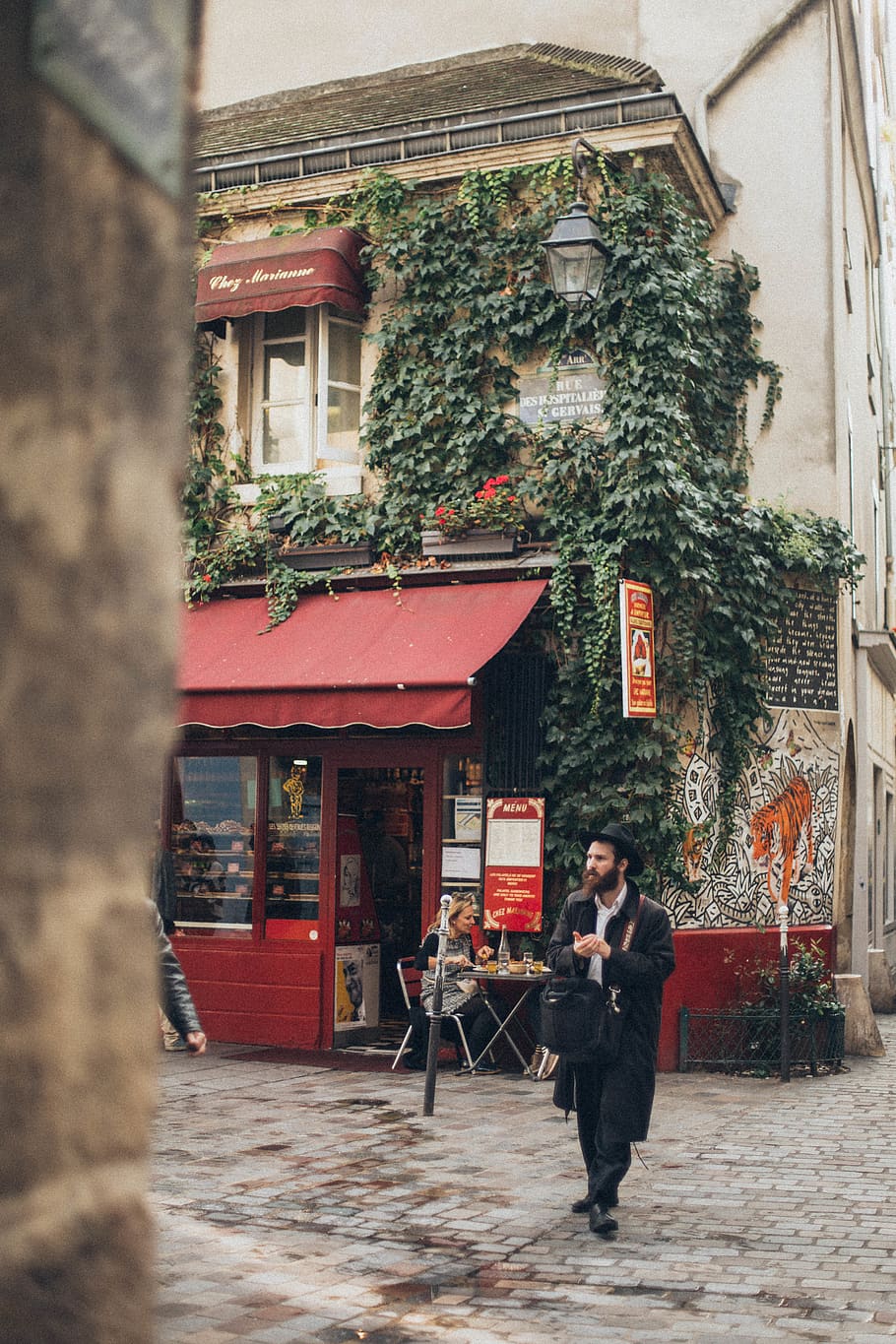 Man Walking Beside Gray and Red House, architecture, commerce HD wallpaper