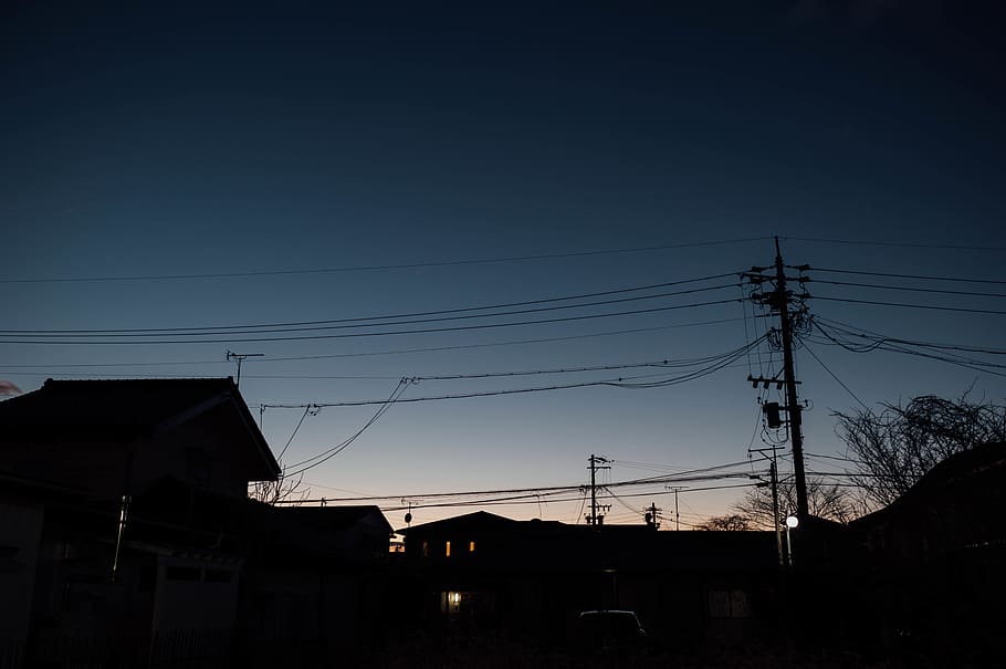 silhouette of houses during golden hour, cable, power lines, electric transmission tower