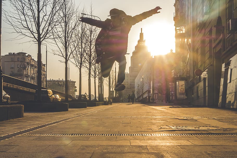 Silhouette of Person Jumping Beside Withered Trees, active, architecture HD wallpaper