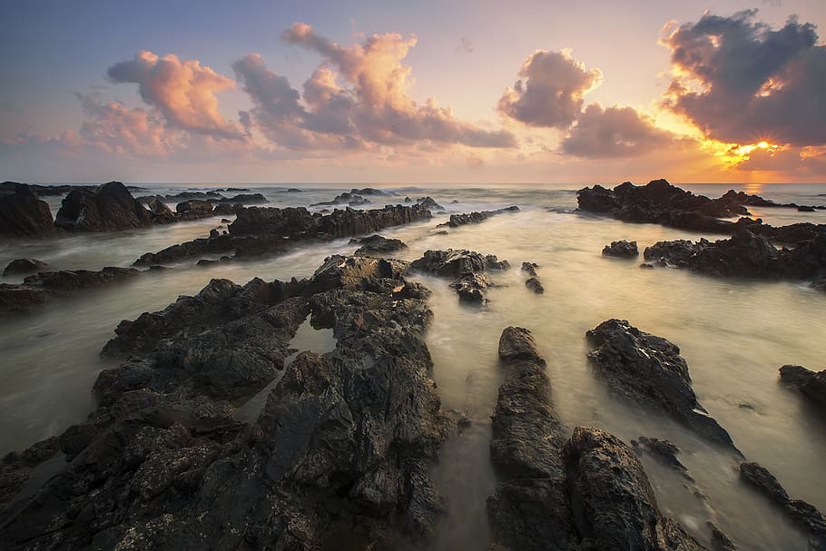 Black Rocks Surrounded by Body of Water during Daytime, beach HD wallpaper