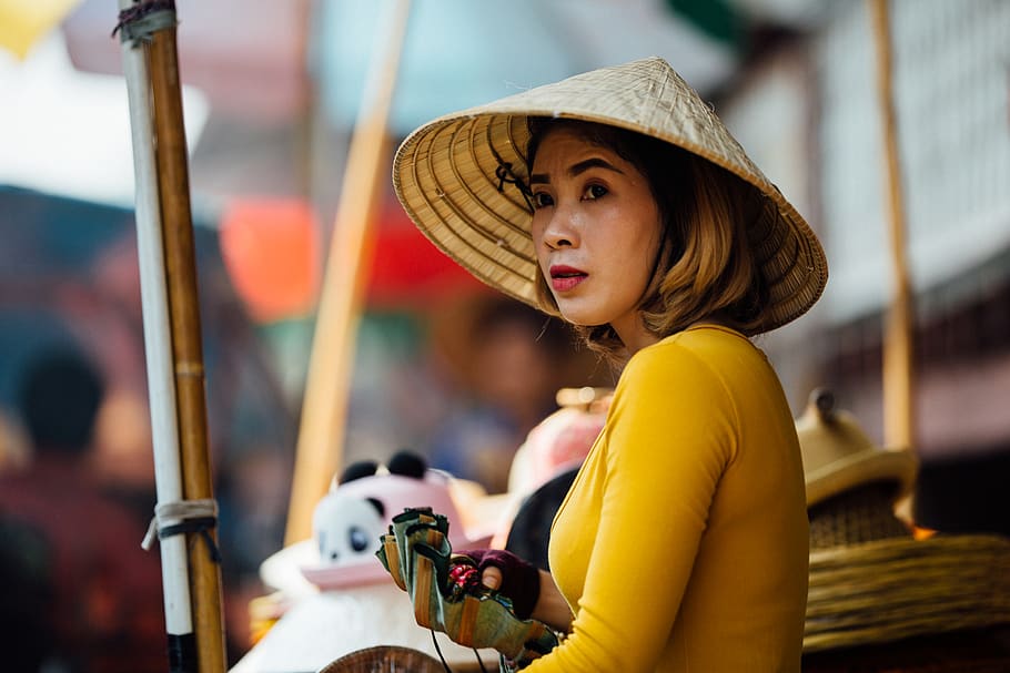 selective focus photography of woman wearing conical hat holding gray container, HD wallpaper