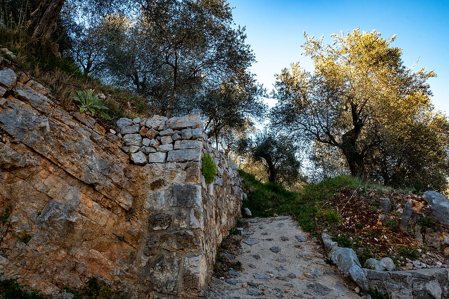 walkway, path, human, person, ground, stone wall, rubble, bunker
