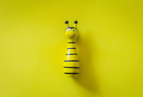 Yellow and White Ceramic Bee Table Decor on Yellow Surface, close-up HD wallpaper