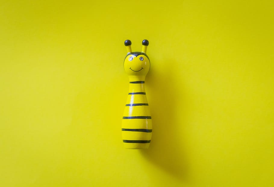 Yellow and White Ceramic Bee Table Decor on Yellow Surface, close-up HD wallpaper