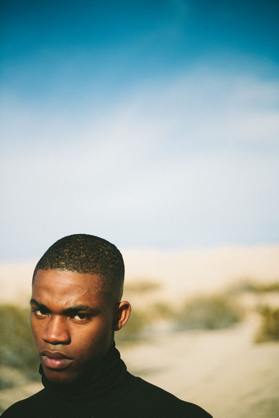 man wearing black top, one person, portrait, headshot, focus on foreground HD wallpaper