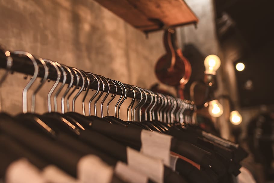 Photo of Black Clothes on Hangers, blur, blurred background, boutique